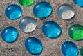 White, blue and green glass beads on sand Royalty Free Stock Photo