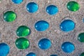 White, blue and green glass beads on sand Royalty Free Stock Photo