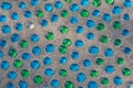 White, blue and green glass beads on sand Royalty Free Stock Photo