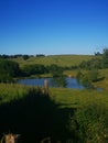 Landscape over the green grass and a little blue lake in Bourgogne France