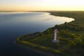 Landscape overlooking the river and lighthouse. Dawn. The water is shiny. Aerial