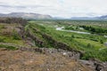 Landscape with Oxara river near Thingvallavatn lake with rocky range in Thingvellir, Iceland in overcast weather