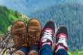 Landscape, travel, tourism. A pair of feet in the shoes against the background of the mountains. Horizontal frame Royalty Free Stock Photo