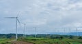 Landscape of panorama wind turbines in agricultural fields with cloudy sky. Renewable friendly energy concept