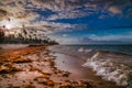 Landscape of paradise tropical island beach, sunset shot against the sun. Royalty Free Stock Photo