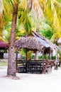 Landscape of paradise tropical island with palms cottages and white sand beach Royalty Free Stock Photo