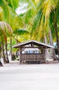 Landscape of paradise tropical island with palms cottages and white sand beach Royalty Free Stock Photo