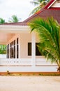 Landscape of paradise tropical island with palms cottages and white sand beach Royalty Free Stock Photo