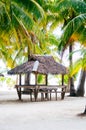 Landscape of paradise tropical island with palms cottages and white sand beach Royalty Free Stock Photo