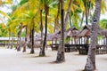 Landscape of paradise tropical island with palms cottages and white sand beach Royalty Free Stock Photo