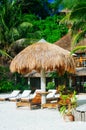 Landscape of paradise tropical island with palms cottages and white sand beach Royalty Free Stock Photo