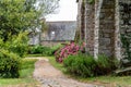 Landscape of pathway outside an old brick wall building in Brittany, France