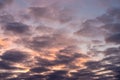 Landscape photo of big, pink cumulonimbus clouds in a stormy sky at sunset. Moody sunset or sunrise sky. Royalty Free Stock Photo