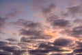 Landscape photo of big, pink cumulonimbus clouds in a stormy sky at sunset. Moody sunset or sunrise sky. Royalty Free Stock Photo