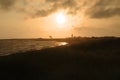 Landscape photo with grass, wind kite surfer, people on the beach and lighthouse