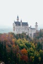 Landscape picture of Neuschwanstein castle near Munich in Bavaria, Germany in Autumn with colorful trees Royalty Free Stock Photo