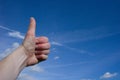 Thumbs up with a blue sky background