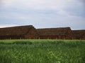 Landscape photo pyramid square stack of hay bales on the green field Royalty Free Stock Photo