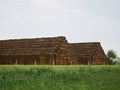 Landscape photo pyramid square stack of hay bales on the green field