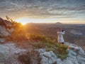 Landscape photograper with hand on camera and tripod