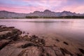 A landscape photograph of a beautiful mountain range and golden pink clouds after sunset Royalty Free Stock Photo