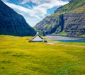 Landscape photography. Amazing summer view of turf-top Saksunar Kirkja in Saksun village, Faroe Islands.