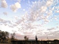 Landscape photography beautiful autumn sky at sunset with cumulus clouds on a turquoise sky and trees below Royalty Free Stock Photo