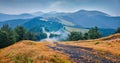 Landscape photography. Dramatic summer scene of Krasna range with old country road. Royalty Free Stock Photo