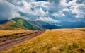 Landscape photography. Dramatic summer scene of Svydovets mountain range with old country road. Royalty Free Stock Photo