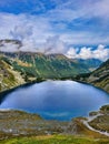 Landscape photography. Lake and mountain. Aerial view. Landscape with mountain lake and patches of snow. Water reservoir with