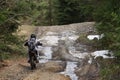 Motorcyclist travels through forest and mountainous