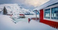 Landscape photography. Traditional Norwegian red wooden houses on the shore of frozen fjord. Royalty Free Stock Photo