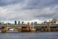 Landscape picture of railway truss bridge over Thames river.