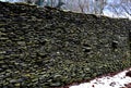 a landscape plagued by frost and snow with walls of flat stones