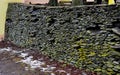 a landscape plagued by frost and snow with walls of flat stones