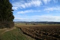 Landscape with a ploughed field and blue sky Royalty Free Stock Photo