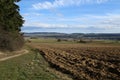 Landscape with a ploughed field and blue sky Royalty Free Stock Photo