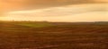 plowing farmland with evening sky