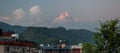 Landscape with Pokhara rooftops on sunrise with Annapurna South, Hiunchuli and Machapuchare Fishtail Peaks in background. Himalay