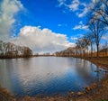 pond with reflection in water beautiful sky, dry reeds and early spring trees Royalty Free Stock Photo