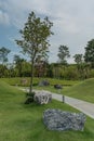Landscape, public park with mowed lawn, walking path and stones. Royalty Free Stock Photo