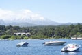 Landscape of Pucon volcano erupting and lake Villarrica and Marina with yachts Royalty Free Stock Photo