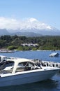 Landscape of Pucon volcano erupting and lake Villarrica and Marina with yachts Royalty Free Stock Photo