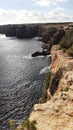 Landscape of Punta Prima cliffs in the coast of Formentera with blue sky, vertical shot Royalty Free Stock Photo