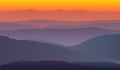 Landscape with purple orange silhouettes of mountains