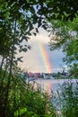 Landscape with a rainbow over a pond and a forest Royalty Free Stock Photo