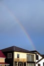 Landscape with rainbow after rain above cottage village homes