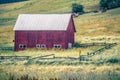Landscape with a red barn in rural Montana and Rocky Mountains Royalty Free Stock Photo