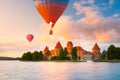 Landscape with red brick castle on island and flying air balloon in Trakai Royalty Free Stock Photo