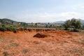 Landscape with red dry cracked soil between hills and mountains in Xieng Khouang Province, Laos